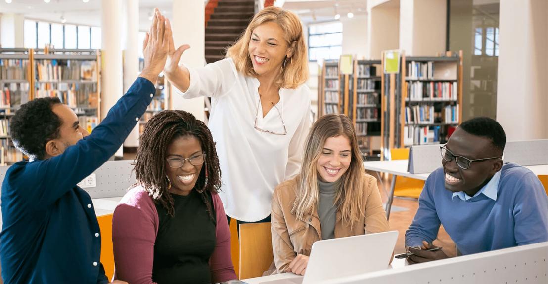 teacher in library helping students