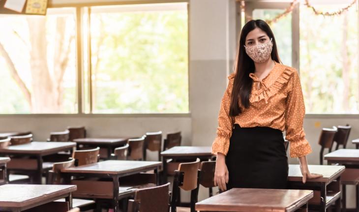 woman teacher wearing a mask in a classroom